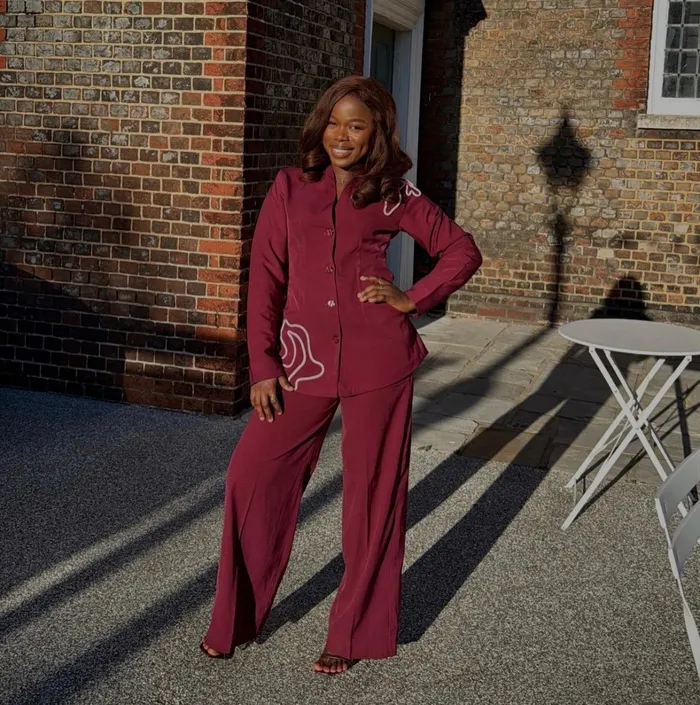 Precious in a burgundy suit in the sunshine